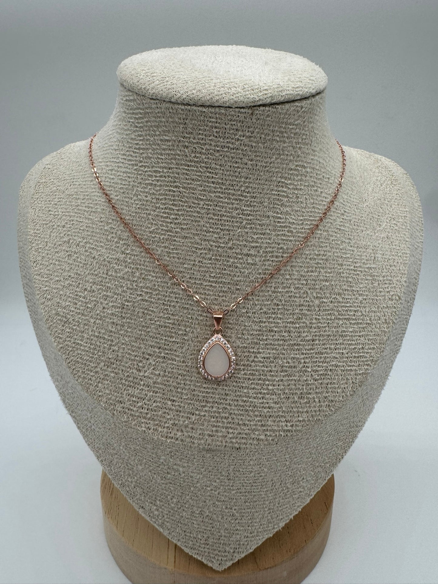 Necklace with a pendant on a mannequin bust against a neutral background