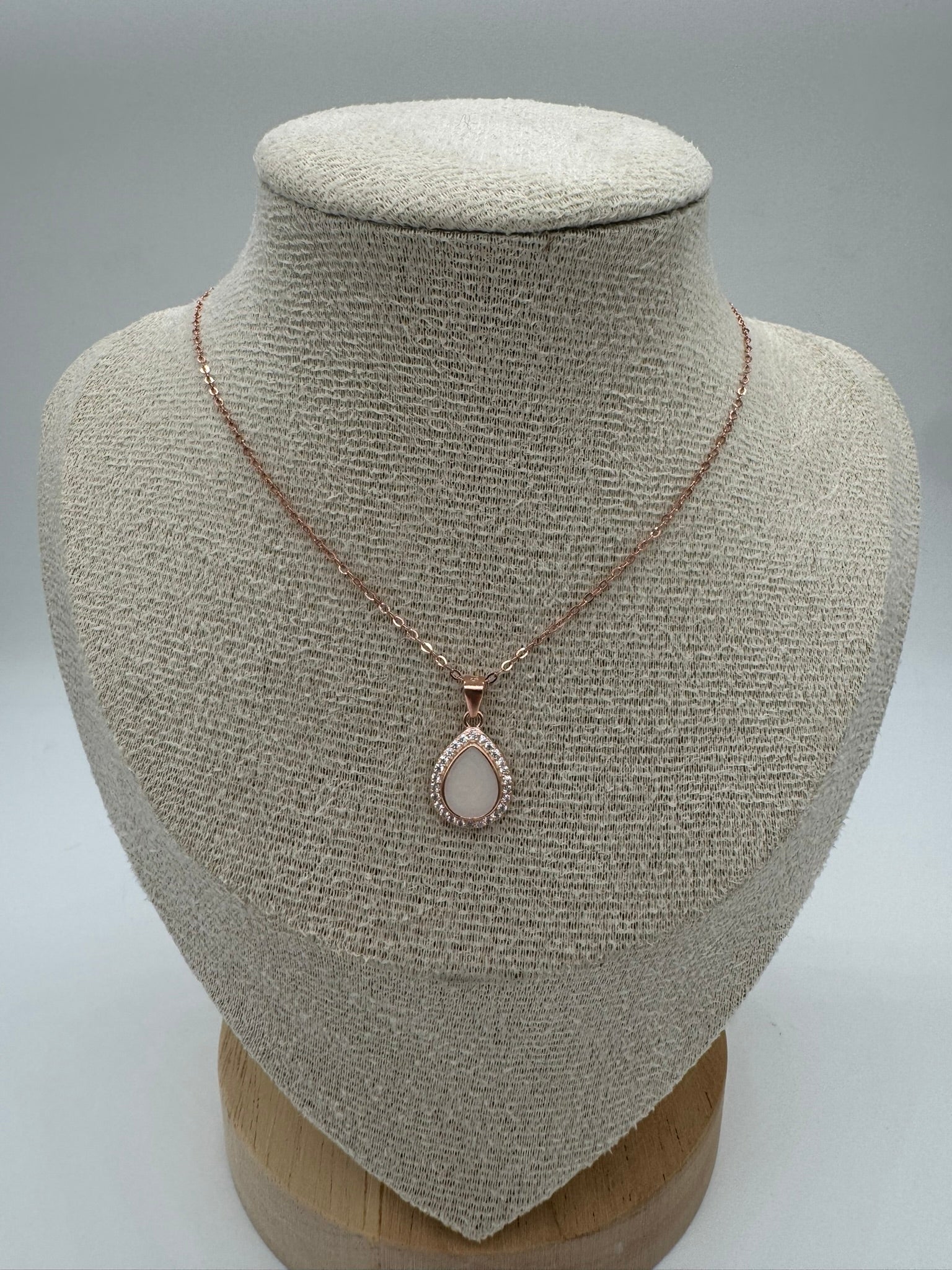 Necklace with a pendant on a mannequin bust against a neutral background