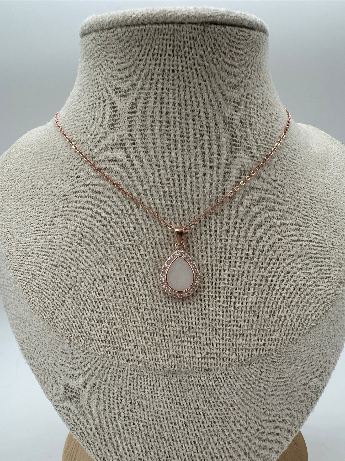 Necklace with a pendant on a mannequin bust against a neutral background