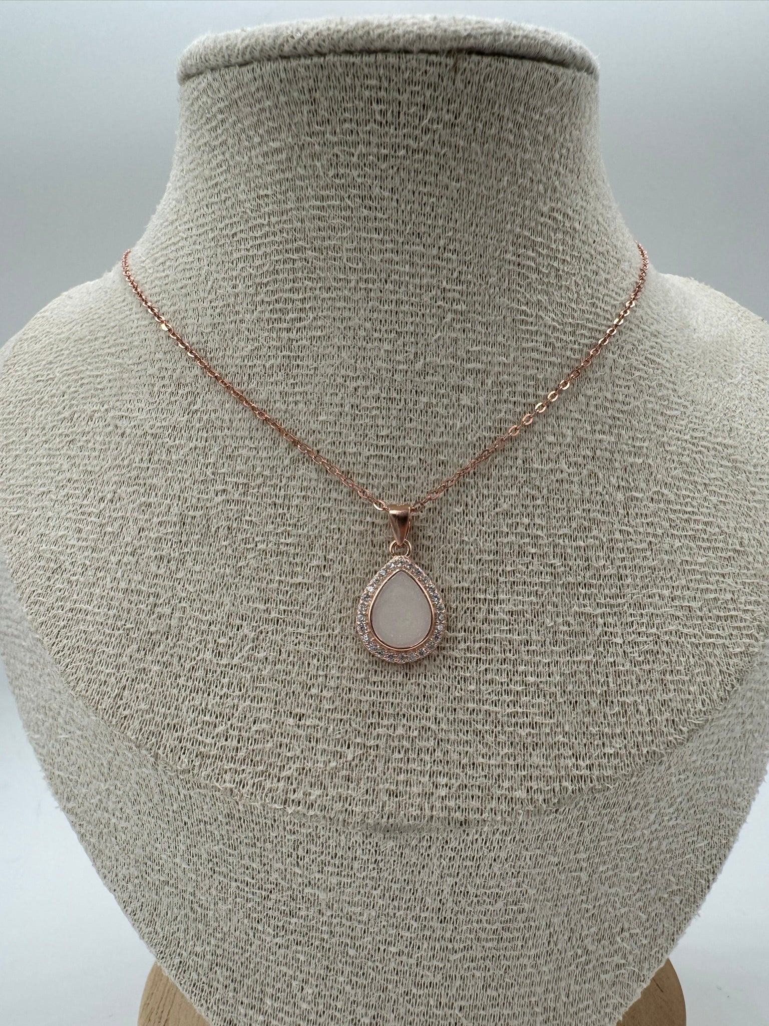 Necklace with a pendant on a mannequin bust against a neutral background